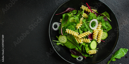 pasta salad Fusilli (leaves Lettuce, Spinach, Vegetables, Gemelli) Menu Concept. food background. copy space. Top view