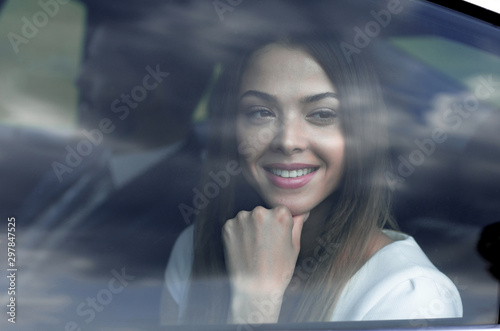thoughtful business woman sitting in car backseat