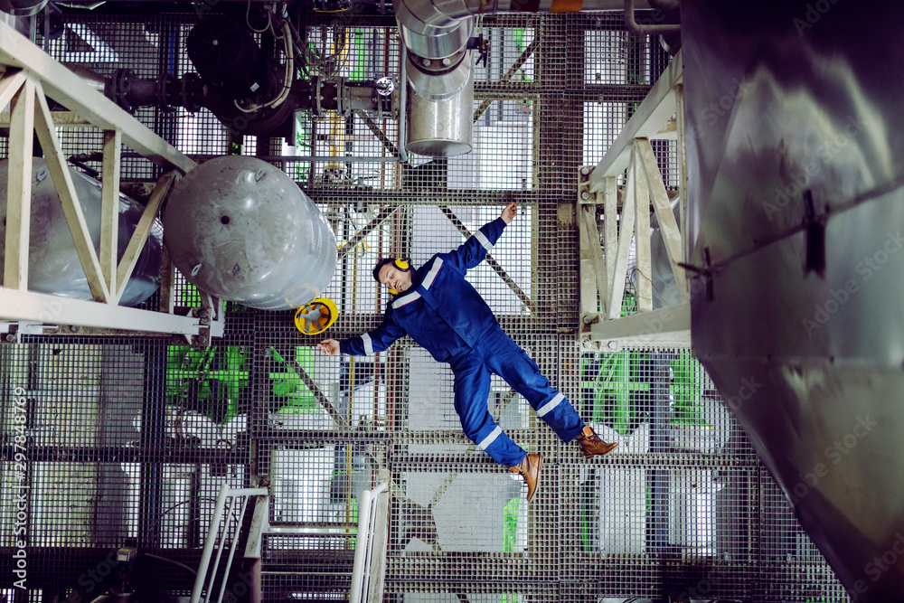 Top view of unconscious plant worker. Injury at work concept. - obrazy, fototapety, plakaty 