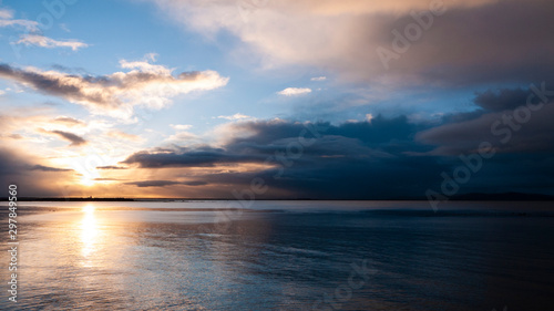 Stunningly beautiful sunrise  taken on a cloudy morning from Salthill beach near Galway  Ireland. Showing the calm water of Galway Bay and Mutton Island in the distance.