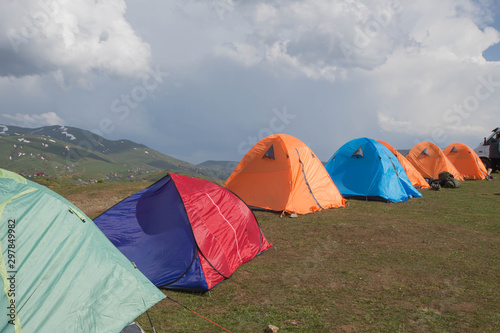 Tourist holiday in a tent in the high mountains. Camping tent in nature