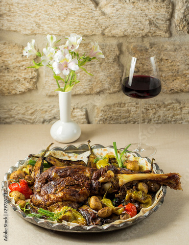 roasted lamb shoulder served with roasted tomato, aubergine and bell peppers