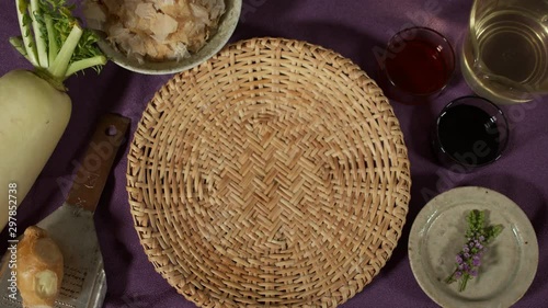 a Japanese female chef picking up KAMONASU (Japanese round aubergine) from her kitchen table, Tokyo, Japan. July 2019. Camera fixed, close up, bird's eye view photo