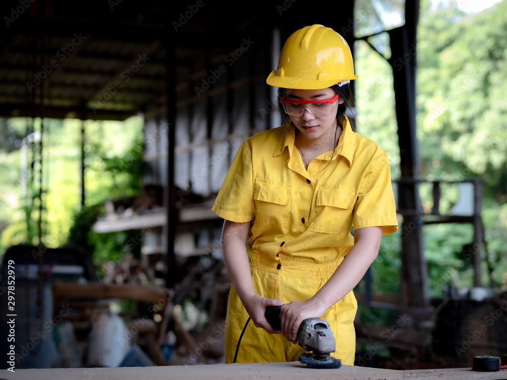A woman in a uniform working in a technician is preparing to use the tools A woman in a uniform working in a technician is preparing to use the tools