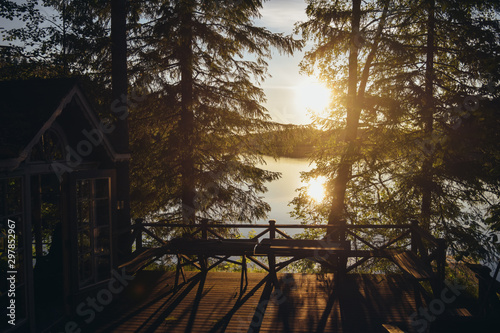 Sunset lake view from a typical summer cottage with sauna in Finland.