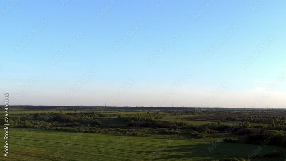 Beautiful view panorama of Village with houses and gardens on a river surrounded by green pastures with stunning landscape cinematic views. Concept climate outdoor nature. Beautiful view panorama of Village with houses and gardens on a river surrounded by green pastures with stunning landscape cinematic views. Concept climate outdoor nature.