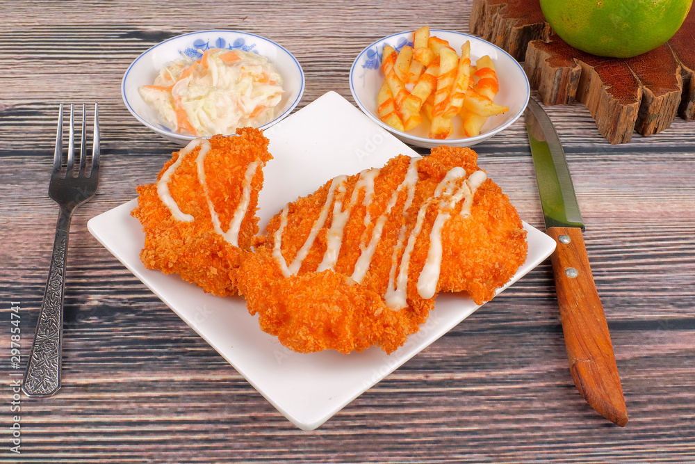Chicken chop in white plate , coleslaw and french fries on wood background Chicken chop in white plate , coleslaw and french fries on wood background
