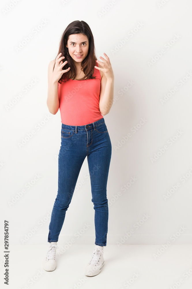 Full body young woman on white background upset screaming with tense hands. Full body young woman on white background upset screaming with tense hands.
