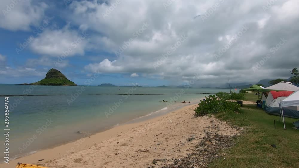 Isolated Hawaiian beach with tents for dispersed camping; government permits are required to camp; some sites are occupied by homeless population of Oahu Island Isolated Hawaiian beach with tents for dispersed camping; government permits are required to camp; some sites are occupied by homeless population of Oahu Island