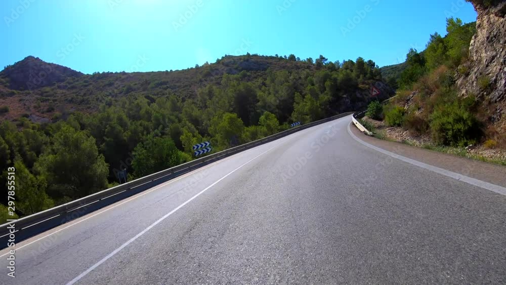 Riding motorcycle on curvy mountain road on a beautiful sunny day, point of view shot Riding motorcycle on curvy mountain road on a beautiful sunny day, point of view shot