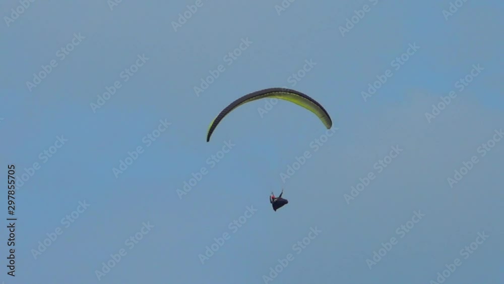 Paraglider flying in air,blue sky on sunny day,follow close up shot Paraglider flying in air,blue sky on sunny day,follow close up shot