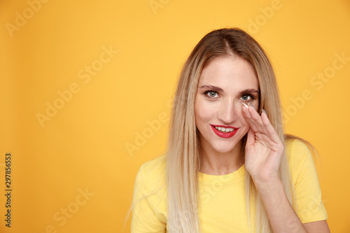 Young woman talking a secret isolated