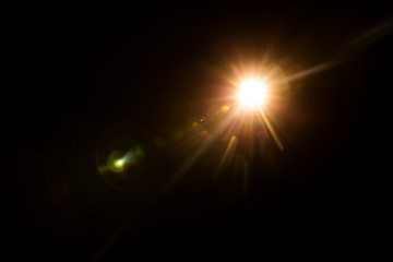 abstract lens flare red light over black background