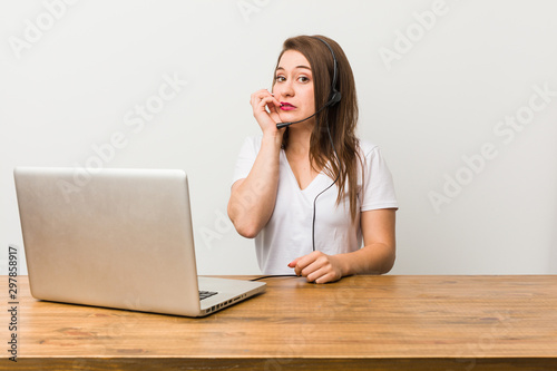 Young telemarketer woman biting fingernails, nervous and very anxious.