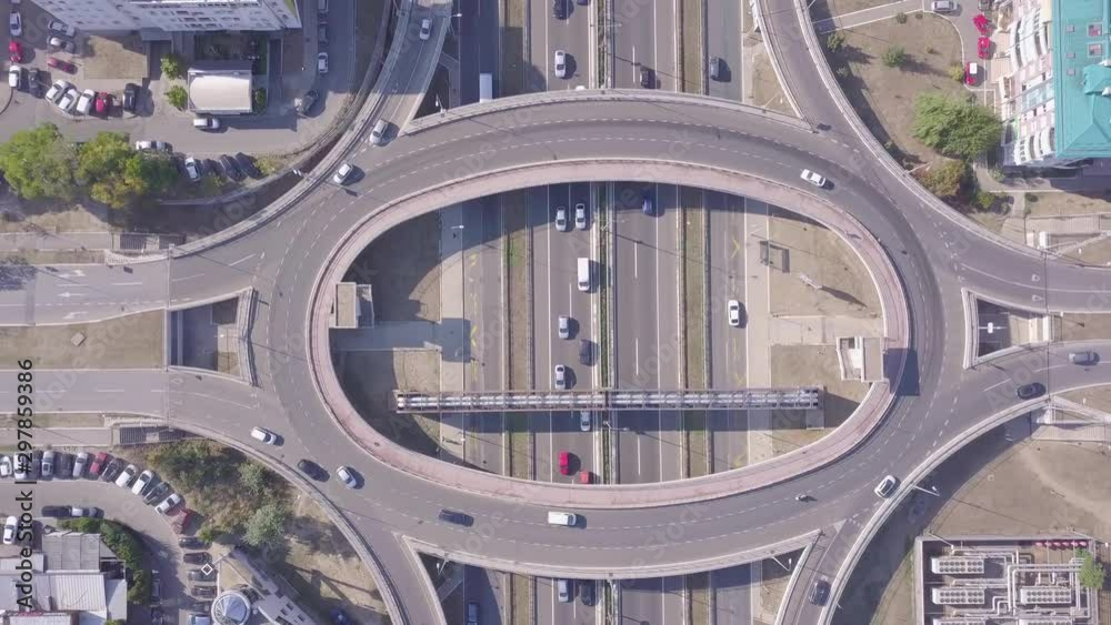 Descending aerial shot of Roundabout and highway, 4k traffic Descending aerial shot of Roundabout and highway, 4k traffic