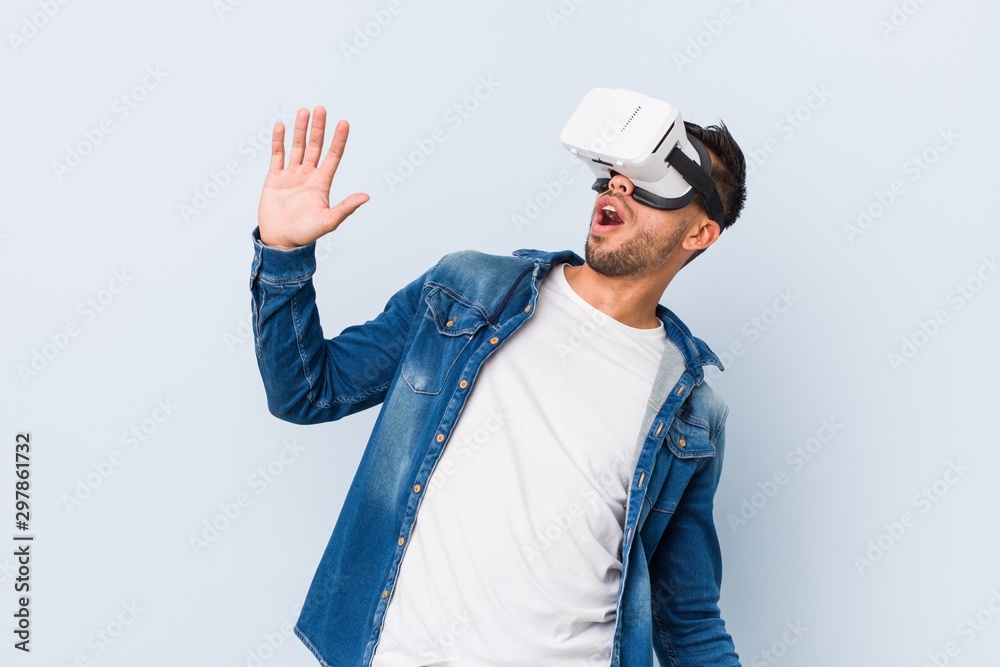 Young south-asian man playing with virtual reality glasses Young south-asian man playing with virtual reality glasses