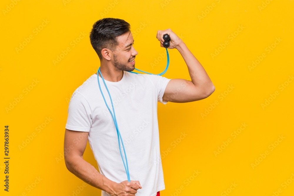 Young south-asian man holding a jump rope. Young south-asian man holding a jump rope.