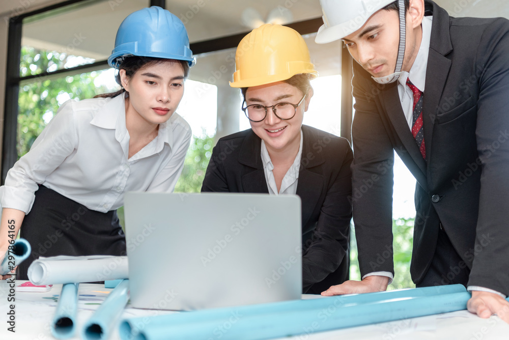 Team of professional engineers working with blueprints Team of professional engineers working with blueprints