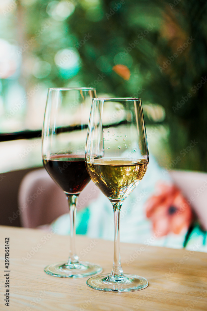 a glass of white and red wine in the cafe a glass of white and red wine in the cafe