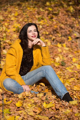 Beautiful young woman in autumn park on a sunny day
