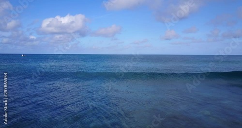 Dreamline view of the open tropical sea with medium waves and nautical  vessel  photo