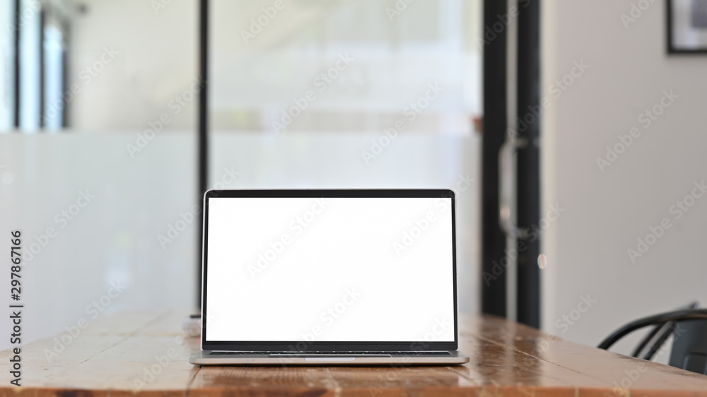 Mockup laptop computer on wooden table with blank screen. Mockup laptop computer on wooden table with blank screen.