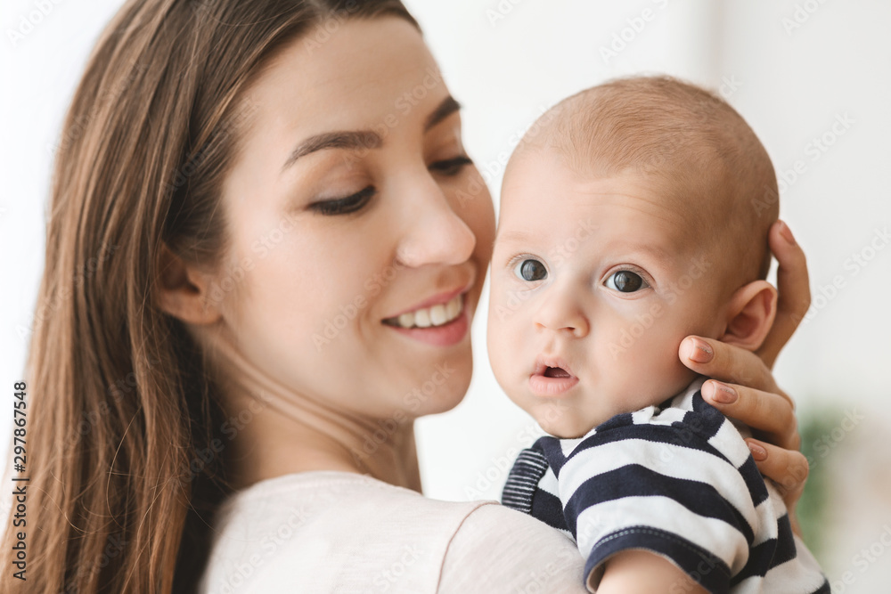 Portrait of beautiful mother hugging her newborn child Portrait of beautiful mother hugging her newborn child