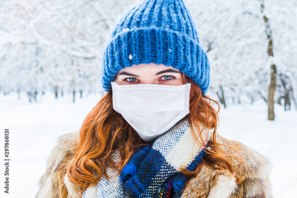 young woman in protective mask in winter in outdoors young woman in protective mask in winter in outdoors