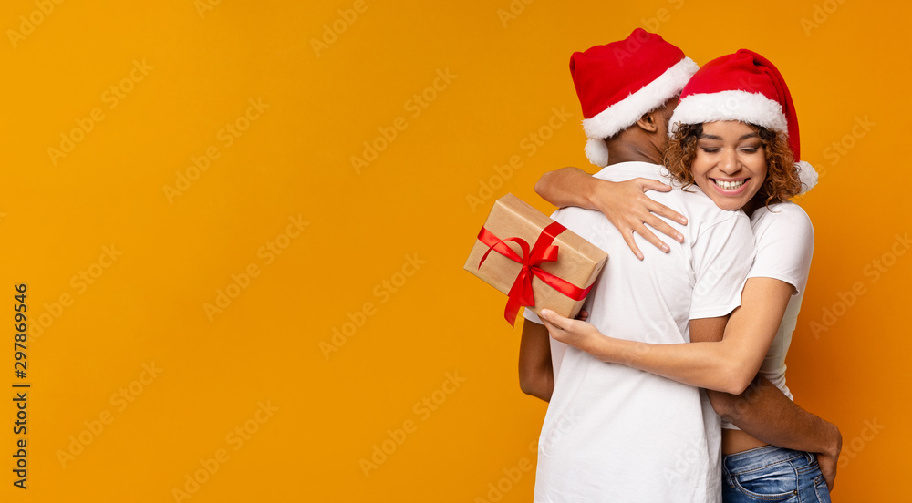 Obraz premium Happy black girl embracing her boyfriend for lovely present
