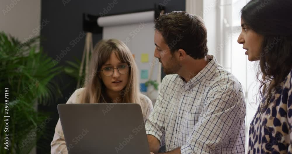 Millennial creative professionals working in a creative office Millennial creative professionals working in a creative office