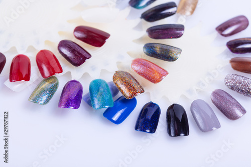 Palette of nail polish for manicure on white background