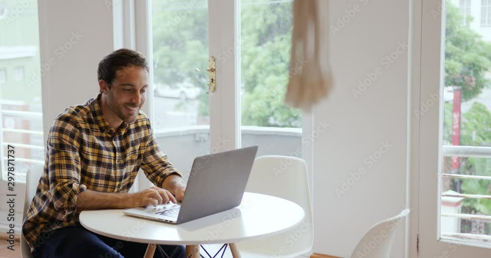 Millennial male professional working in a creative office Millennial male professional working in a creative office