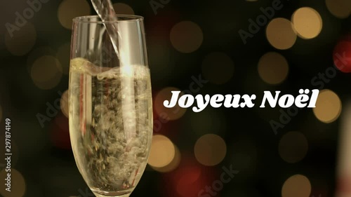 Joyeux NoÃ«l written over champagne flute photo