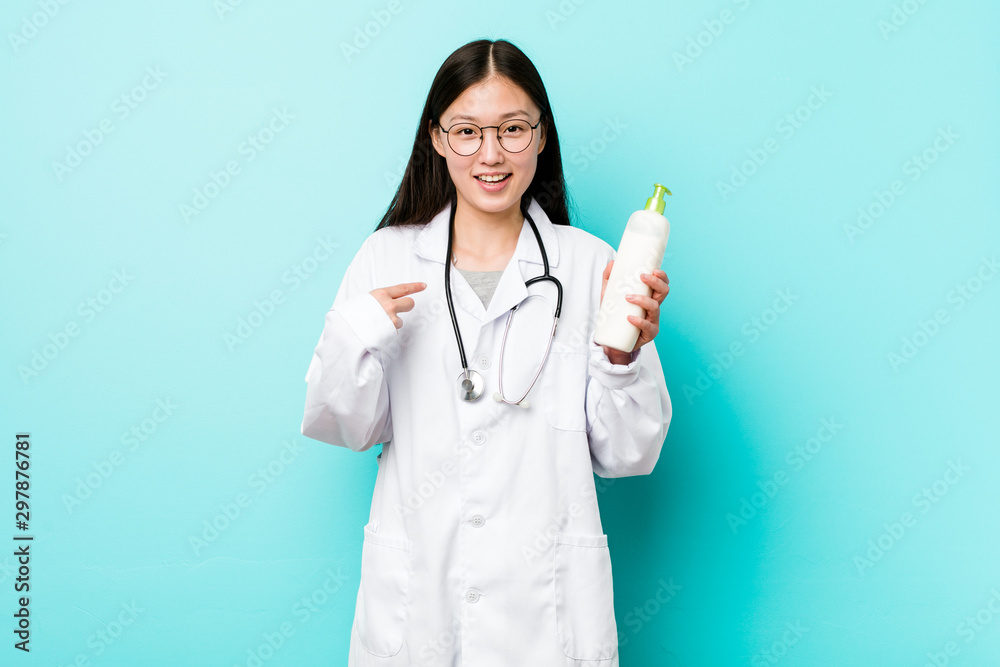 Young asian dermatologist girl surprised pointing at himself, smiling broadly. Young asian dermatologist girl surprised pointing at himself, smiling broadly.