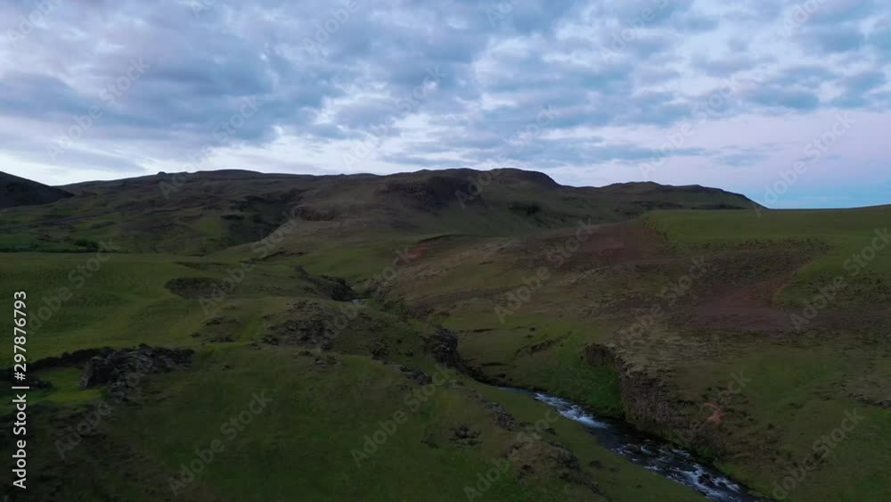 Icelandic highland river valley on overcast day, aerial reveal Icelandic highland river valley on overcast day, aerial reveal