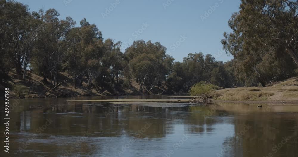 Water flowing through a shallow stream on the banks of MacQuarie River at Ponto Falls Reserve near Dubbo, New South Wales, Australia Water flowing through a shallow stream on the banks of MacQuarie River at Ponto Falls Reserve near Dubbo, New South Wales, Australia