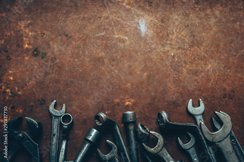 Garage essential instruments. Professional wrench set on rusty dark metal background. Copy space. photo