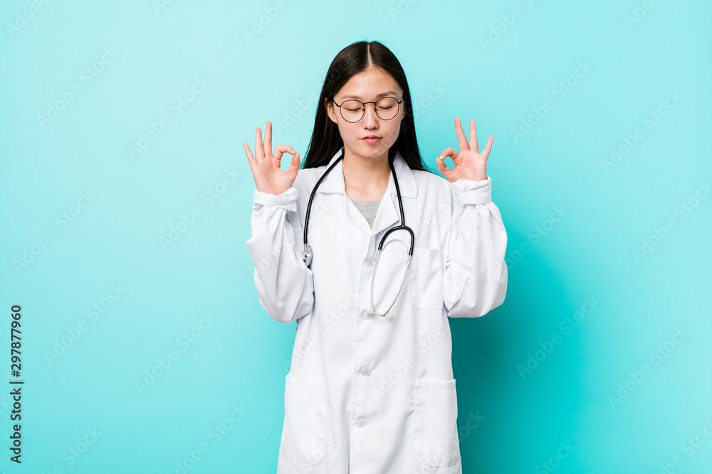 Young chinese doctor woman relaxes after hard working day, she is performing yoga. Young chinese doctor woman relaxes after hard working day, she is performing yoga.