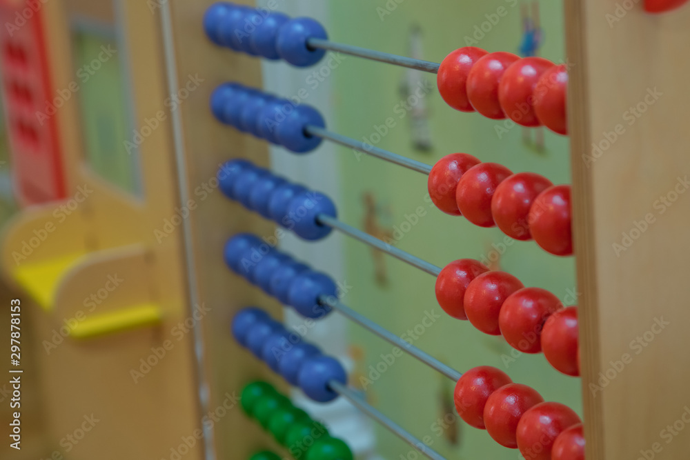 Toy abacus to learn counting. Colorful children counting frame for kids. Top side view.abacus with red green blue and balls . Traditional abacus with colorful wooden beads on white background. Toy abacus to learn counting. Colorful children counting frame for kids. Top side view.abacus with red green blue and balls . Traditional abacus with colorful wooden beads on white background.