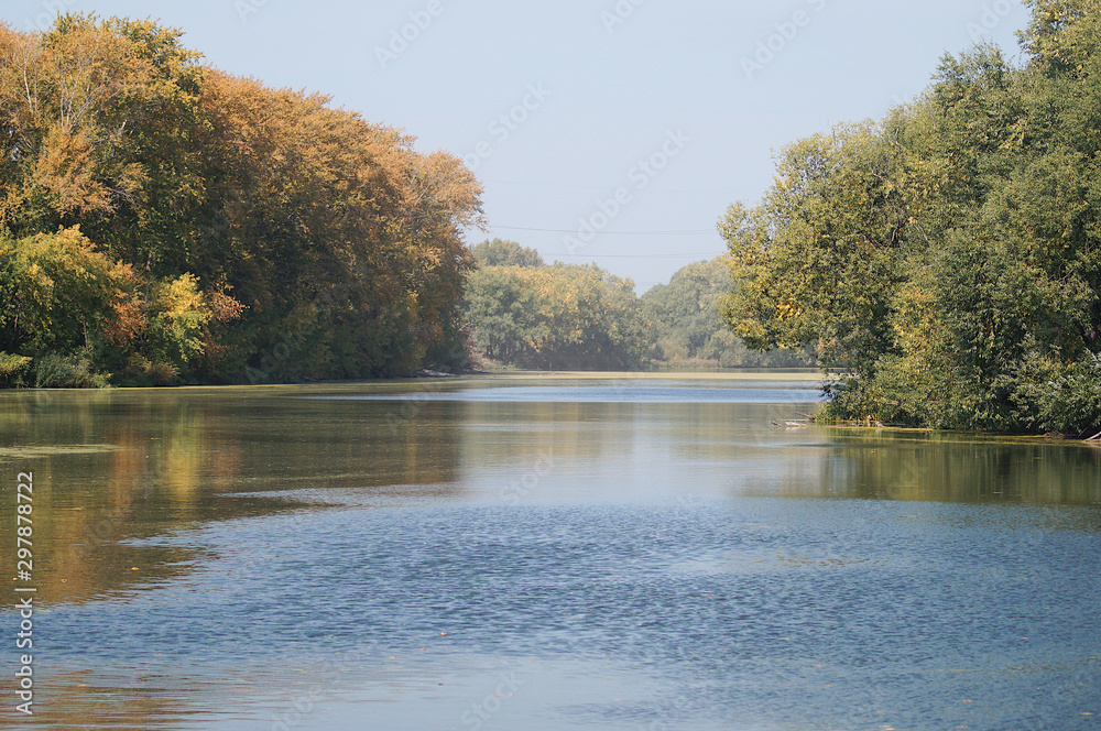Autumn view on river with trees, beautiful water surface with reflection Autumn view on river with trees, beautiful water surface with reflection