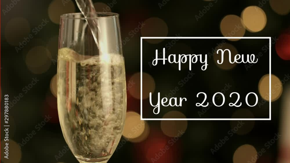 Happy New Year 2020 written in front of champagne flute and lights