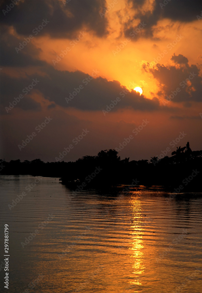 Sunset on the Rupsa River (Rupsha River) near Khulna, Bangladesh. Taken on a river journey between Khulna and the Sundarban Forest. The Sundarbans are in southern Bangladesh.