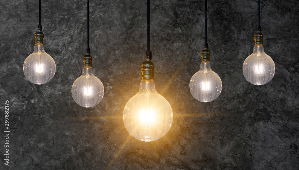 different Light bulb idea Many bulbs are arranged in a row and one of them is illuminated. Concept idea
