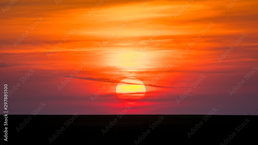 Scenic sky with sun over horizon in the evening_