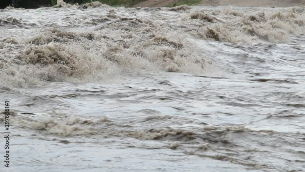 Slow motion of strong turbulent river, detail of waves and foam of water current. Mina Clavero, Cordoba, Argentina Slow motion of strong turbulent river, detail of waves and foam of water current. Mina Clavero, Cordoba, Argentina