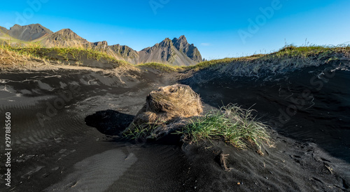 Epic view landscape of the black sand beach in Stokksnes on a sunny day. Vestrahorn mountain in the background. Nature and ecology concept background.