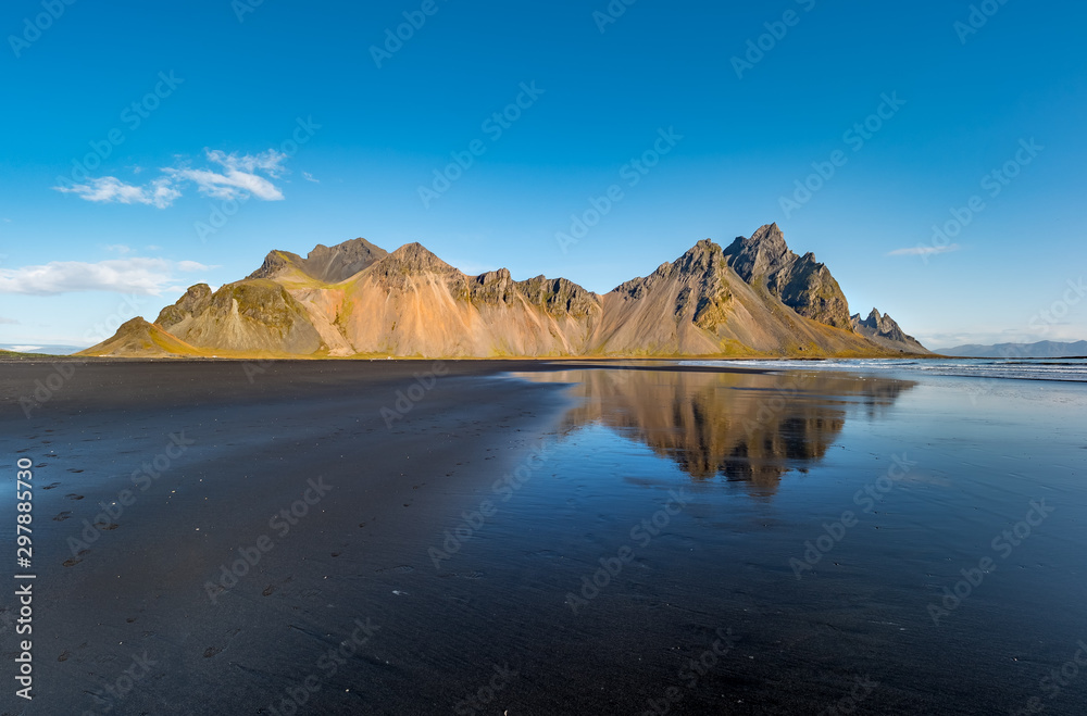 Epic view landscape of the black sand beach in Stokksnes on a sunny day. Vestrahorn mountain in the background. Nature and ecology concept background. Epic view landscape of the black sand beach in Stokksnes on a sunny day. Vestrahorn mountain in the background. Nature and ecology concept background.