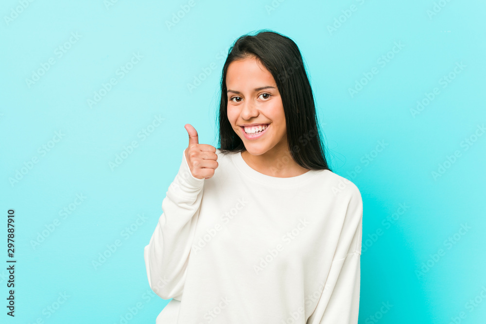 Young pretty hispanic woman smiling and raising thumb up Young pretty hispanic woman smiling and raising thumb up