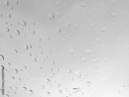 Water drops on glass window over dark sky. Background, Blur.
