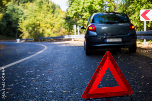 Road breakdown car in nature, forest, autumn, roadside assistance, triangle as a warning sign